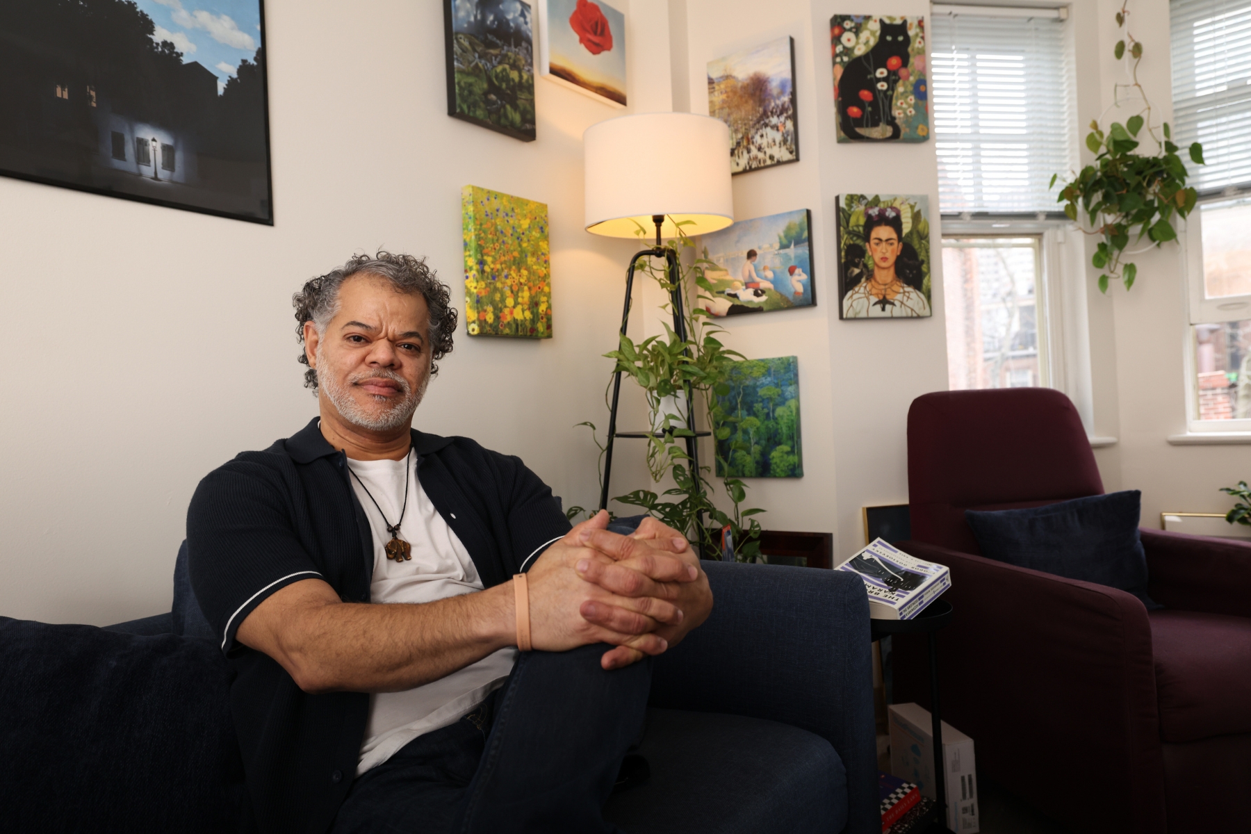 Eduardo Pereira poses for a picture in his Joy Street Residence apartment.